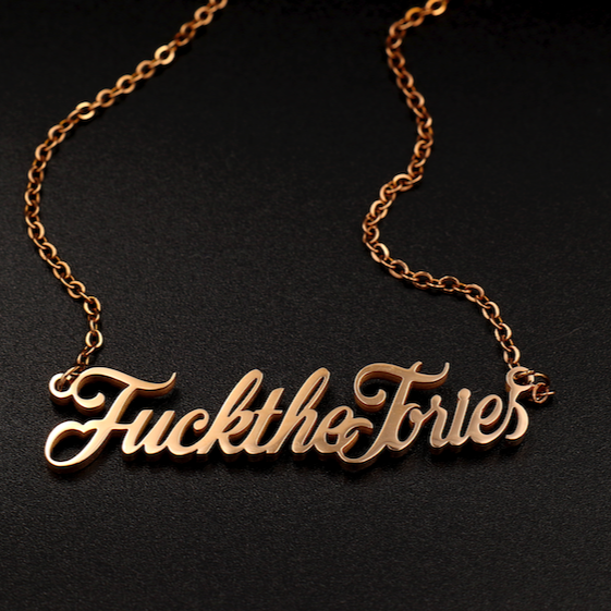 A ‘Fuck The Tories’ necklace by Topple & Burn – bold political jewellery available in rose gold, yellow gold, and silver.