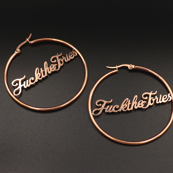 
                  
                    A pair of ‘Fuck The Tories’ hoop earrings by Topple & Burn – bold political jewellery made from surgical steel with gold or silver plating options.
                  
                