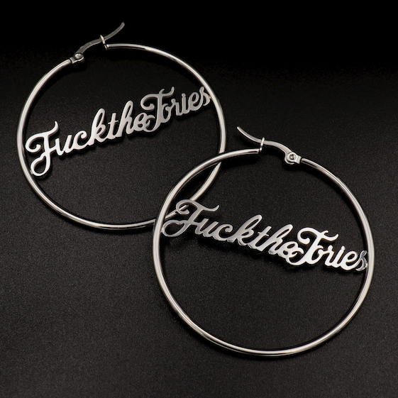 A pair of ‘Fuck The Tories’ hoop earrings by Topple & Burn – bold political jewellery made from surgical steel with gold or silver plating options.