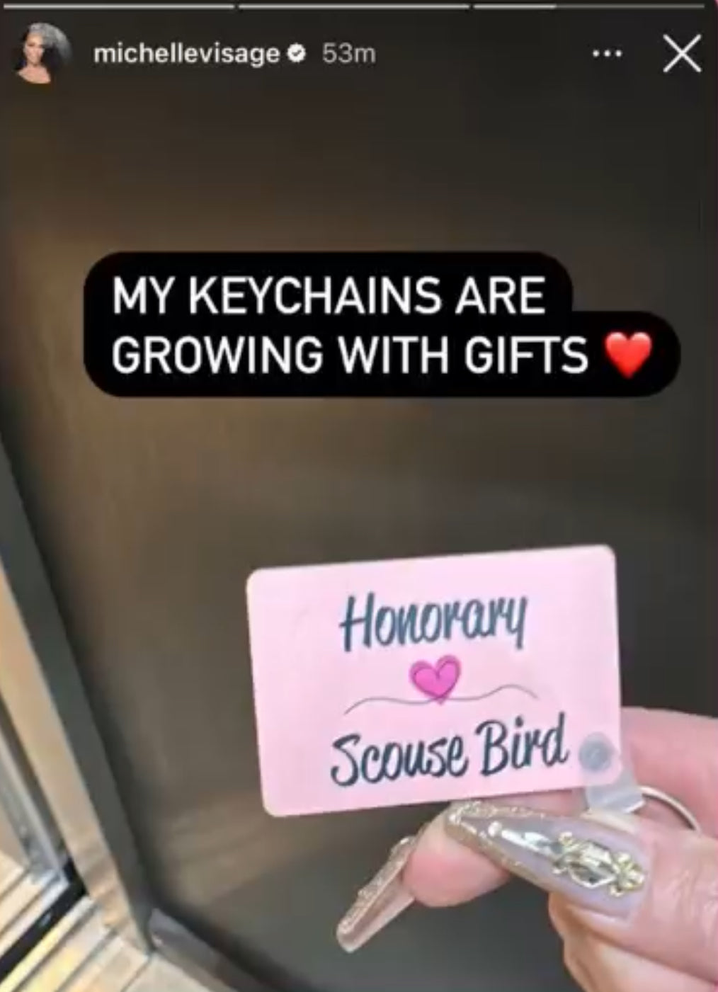 Michelle Visage of drag race holding an honorary scouse bird keyring